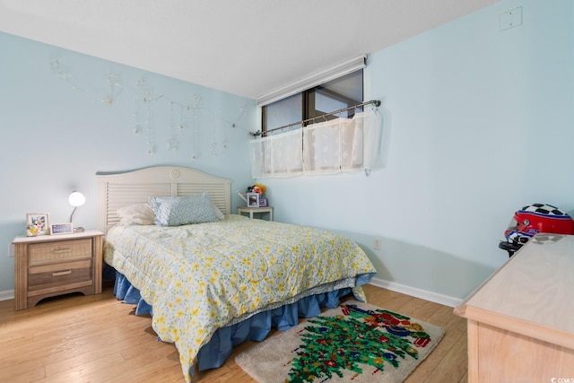 bedroom with hardwood / wood-style floors