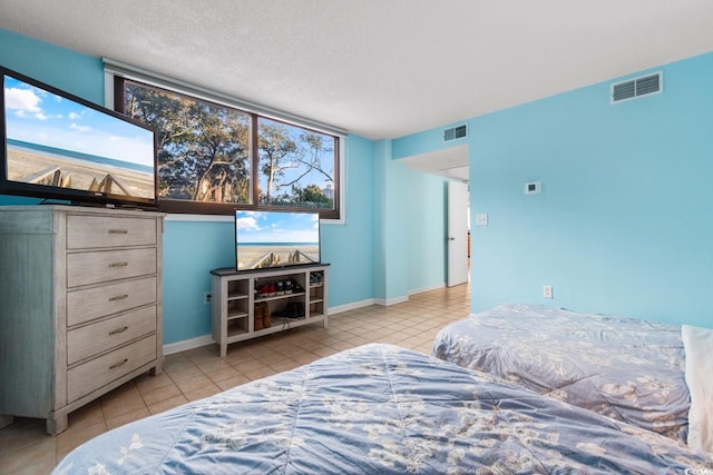 tiled bedroom featuring a textured ceiling