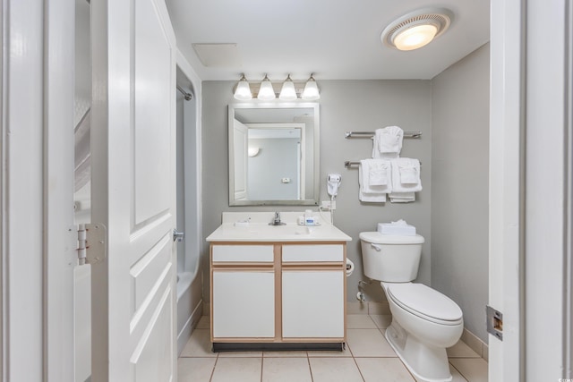 bathroom featuring toilet, vanity, and tile patterned flooring