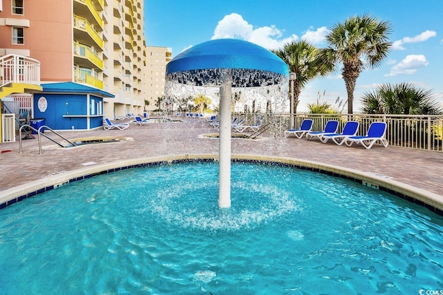 view of swimming pool with a patio area