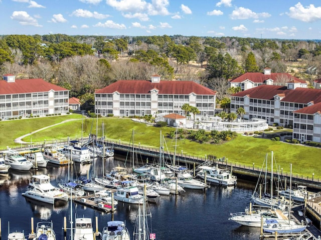 4210 Coquina Harbour Dr Unit A-16, Little River, SC 29566 - dock with view of marina, view of scattered trees, a water view, and a lawn