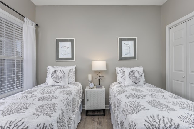 bedroom with a closet and hardwood / wood-style floors