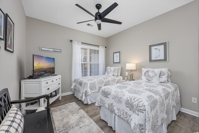 bedroom with ceiling fan and wood-type flooring