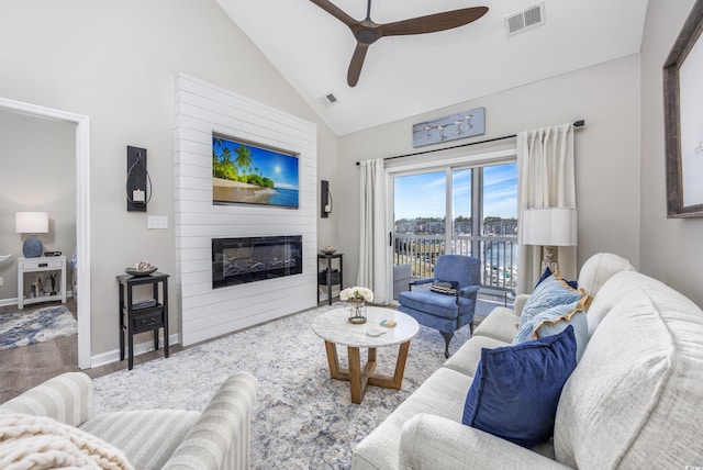 4210 Coquina Harbour Dr Unit A-16, Little River, SC 29566 - living room featuring a fireplace, ceiling fan, wood finished floors, and high vaulted ceiling