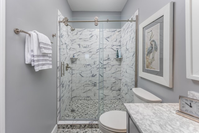 bathroom featuring toilet, vanity, and walk in shower