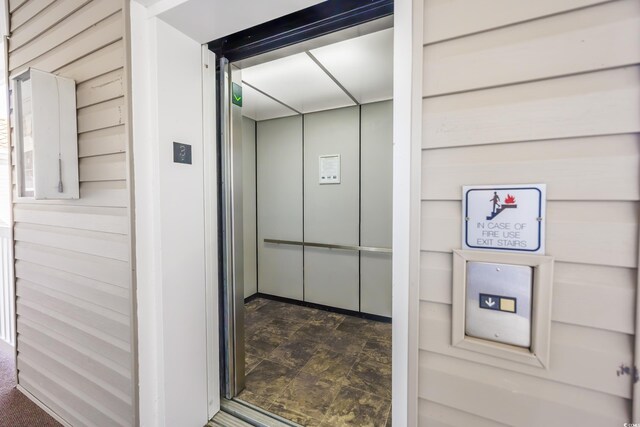 interior details with elevator and wood walls