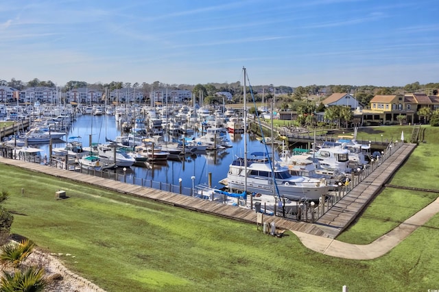 dock area with a water view and a yard