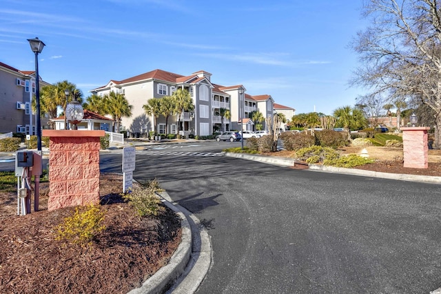 4210 Coquina Harbour Dr Unit A-16, Little River, SC 29566 - view of asphalt road with a residential view, curbs, and street lighting