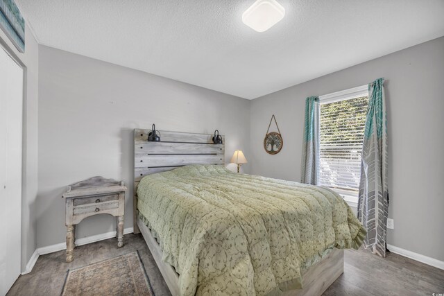 789 University Forest Cir, Conway, SC 29526 - bedroom featuring baseboards, wood finished floors, and a textured ceiling