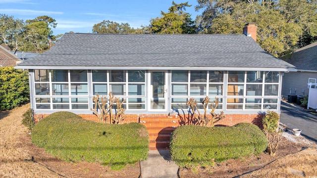 back of house featuring a sunroom