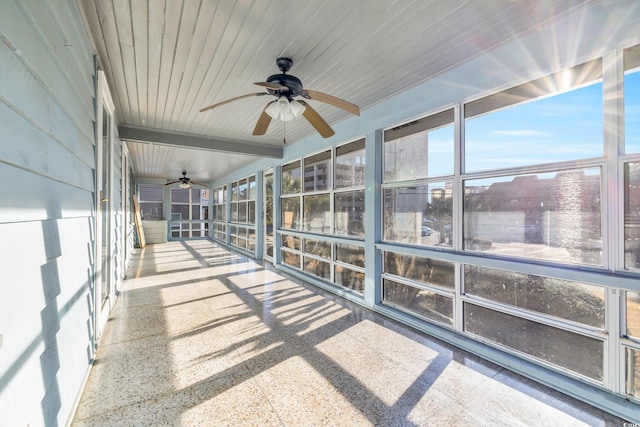 unfurnished sunroom with beam ceiling