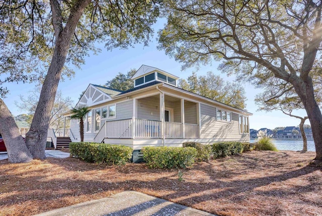 view of front of home featuring a water view and a porch