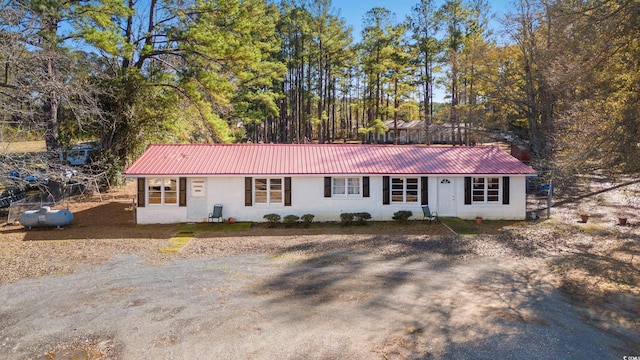 ranch-style home with metal roof