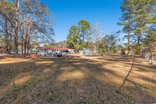 view of yard with playground community and fence