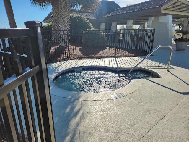 view of swimming pool with a patio area and a hot tub