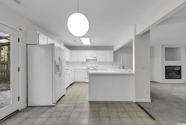 kitchen featuring decorative light fixtures, kitchen peninsula, white appliances, and white cabinetry