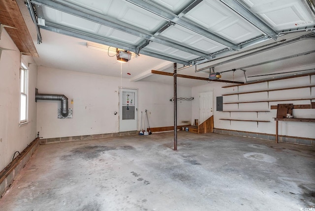 garage featuring electric panel and a garage door opener