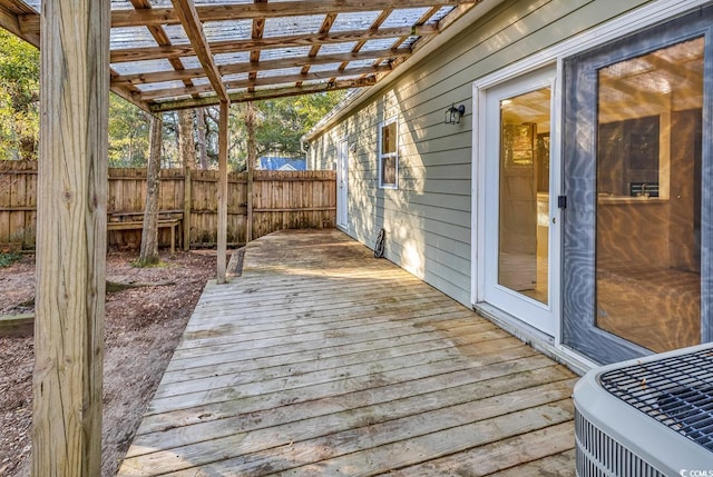 wooden deck with central AC unit and a pergola