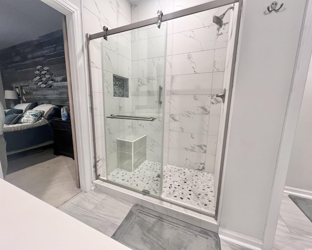 bathroom featuring a shower with shower door