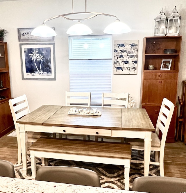 dining space with hardwood / wood-style floors