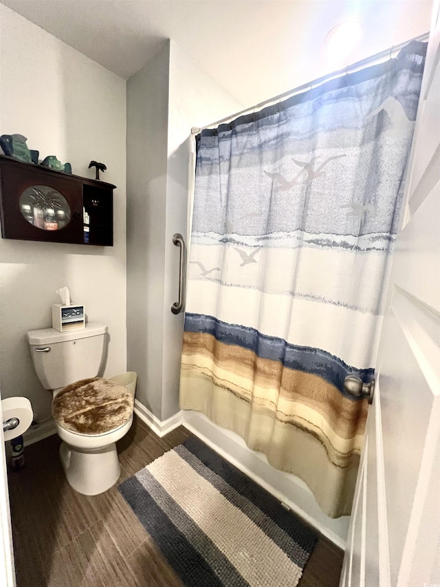 bathroom featuring toilet and a shower with curtain