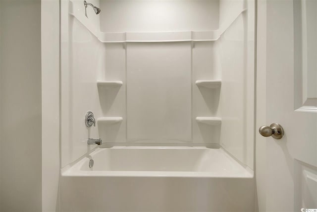 bathroom with bathing tub / shower combination