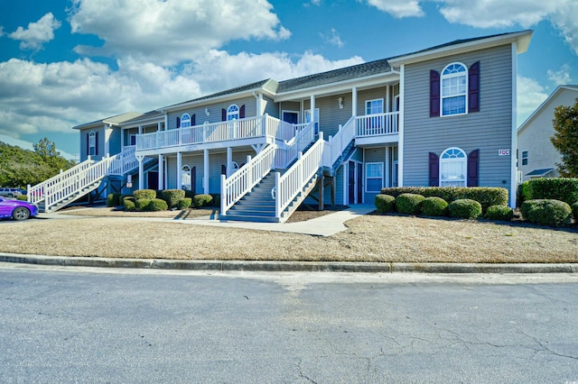 view of front of property with a porch and stairway