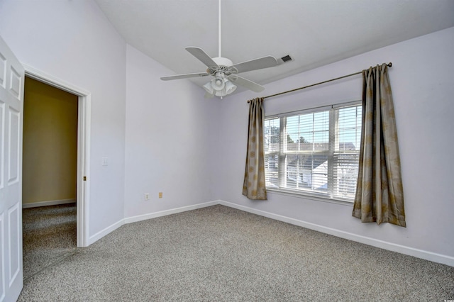 carpeted spare room featuring visible vents, baseboards, and a ceiling fan