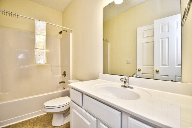 bathroom with washtub / shower combination, vanity, and toilet