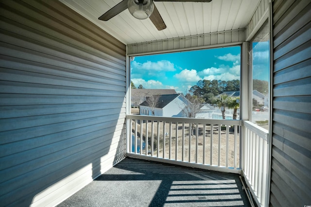 balcony featuring a residential view and a ceiling fan