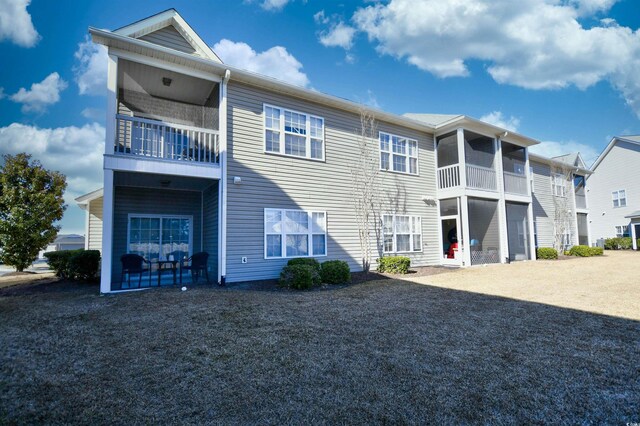 back of house featuring a balcony