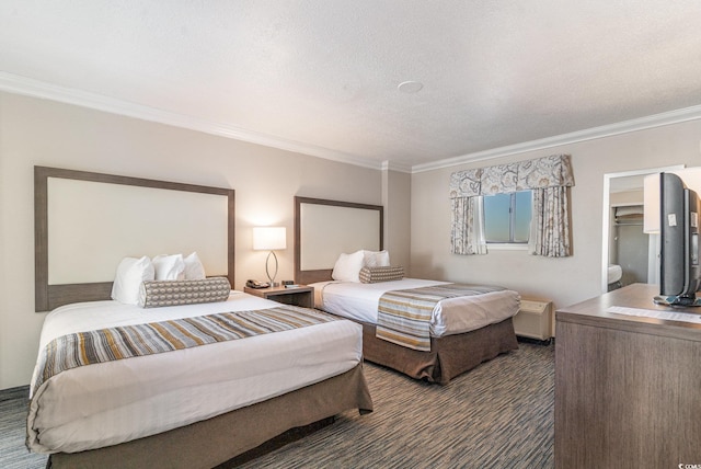 carpeted bedroom with a textured ceiling and ornamental molding