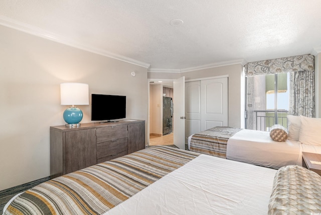 bedroom featuring a textured ceiling, a closet, and crown molding