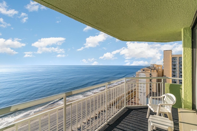 balcony featuring a water view and a view of the beach