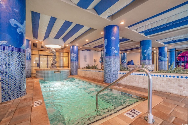 view of swimming pool featuring an indoor hot tub