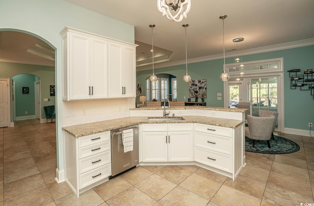 kitchen featuring white cabinetry, a raised ceiling, pendant lighting, stainless steel dishwasher, and sink