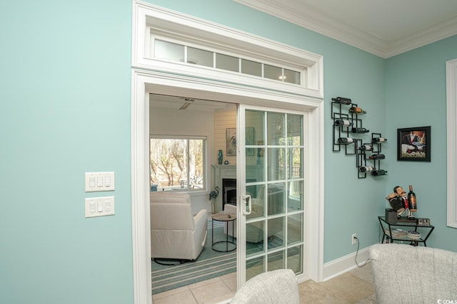 entryway featuring light tile patterned flooring and ornamental molding