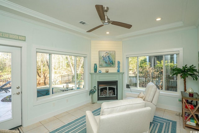 living room featuring ceiling fan, light tile patterned floors, and ornamental molding