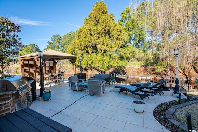 view of patio with an outdoor living space, area for grilling, and a gazebo