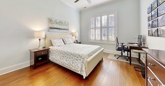 bedroom featuring ceiling fan, crown molding, and dark hardwood / wood-style floors