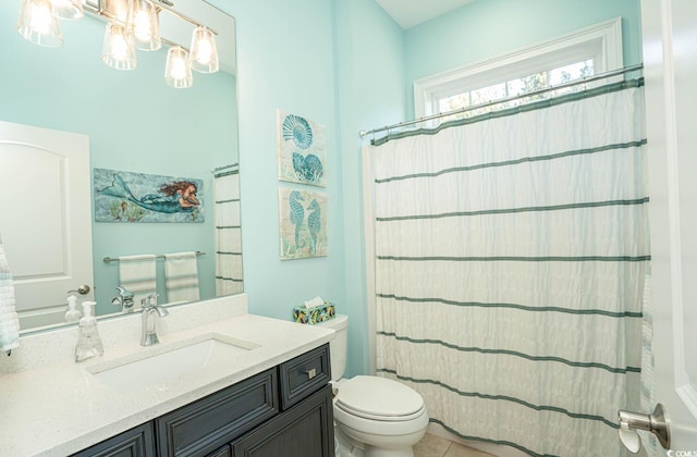 bathroom featuring toilet, vanity, and a shower with curtain