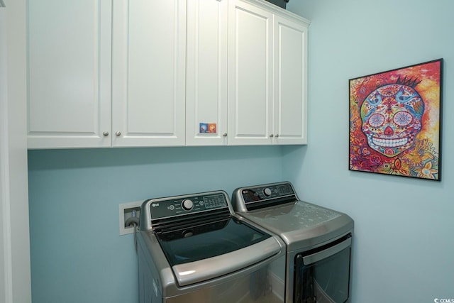 laundry room with cabinets and washer and clothes dryer