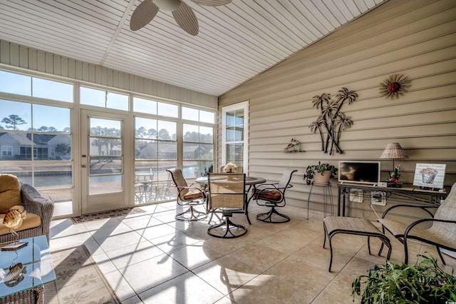 sunroom / solarium with vaulted ceiling, ceiling fan, and a water view