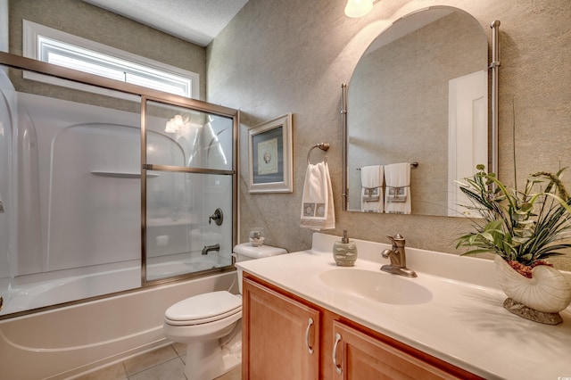 full bathroom featuring a textured ceiling, shower / bath combination with glass door, tile patterned flooring, vanity, and toilet