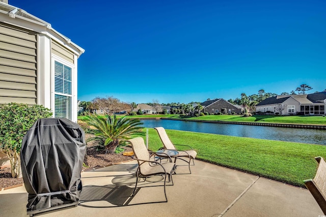 view of patio / terrace featuring grilling area and a water view