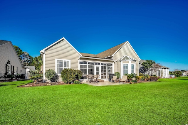 back of house featuring a patio area, a sunroom, and a lawn