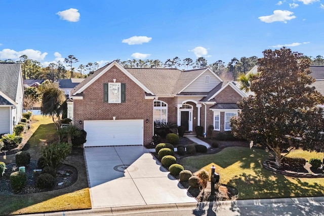 view of front of property with a garage and a front lawn