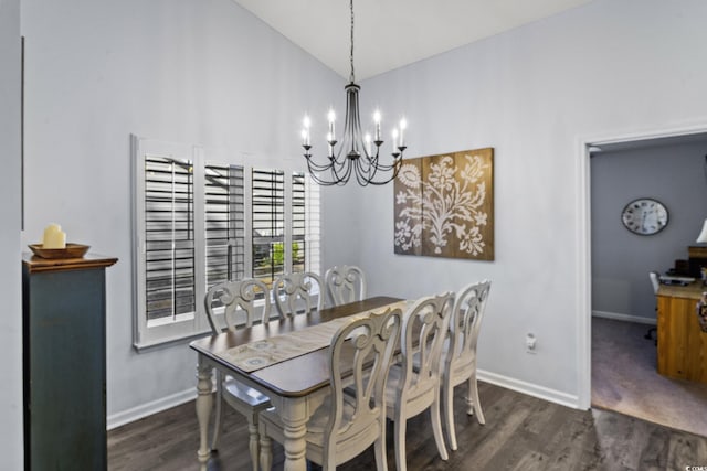 dining space featuring vaulted ceiling, dark hardwood / wood-style floors, and a notable chandelier