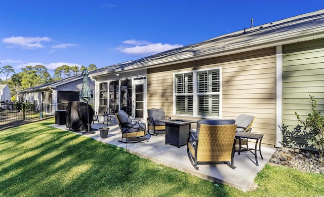 back of house featuring an outdoor fire pit, a patio area, and a yard