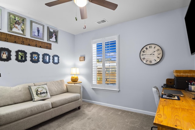 carpeted home office featuring ceiling fan